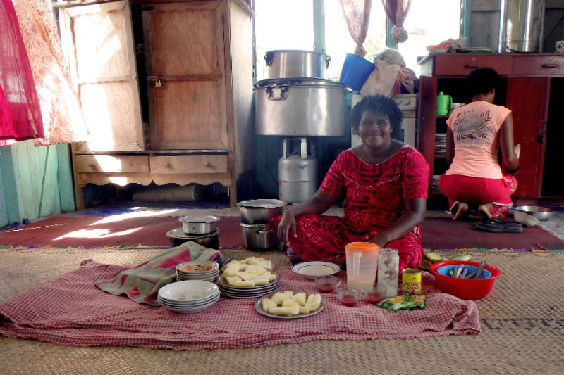 A couple of women from the community start preparing the lunch feast.